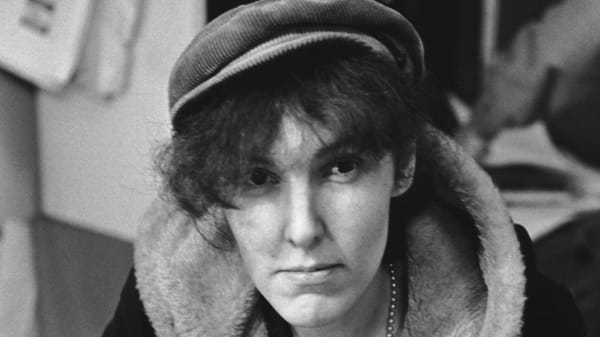 black and white photo of Valerie Solanas, young white woman with narrow face, long nose, and bushy hair covering her forehead